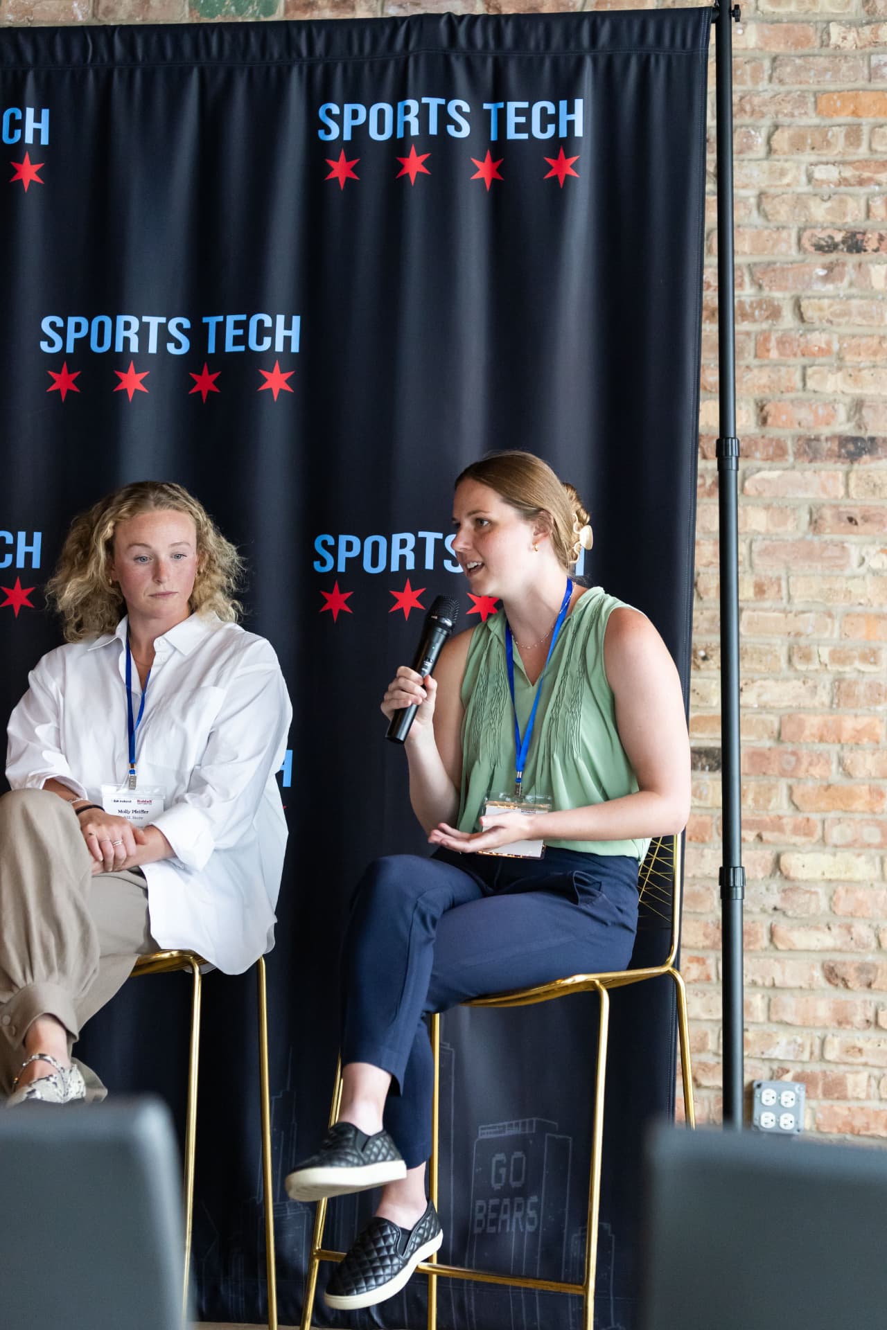 Panelists speaking in front of the Chicago Sports Tech backdrop